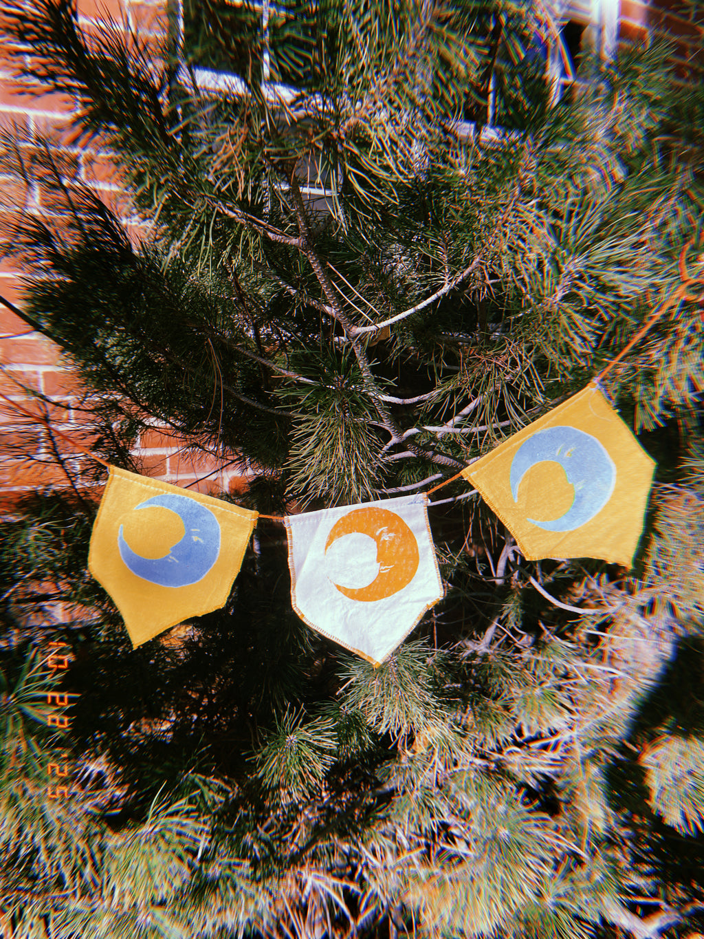 3-flag whimsigoth moon bunting garland, blue, yellow, and gold.