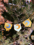 3-flag whimsigoth moon bunting garland, blue, yellow, and gold.