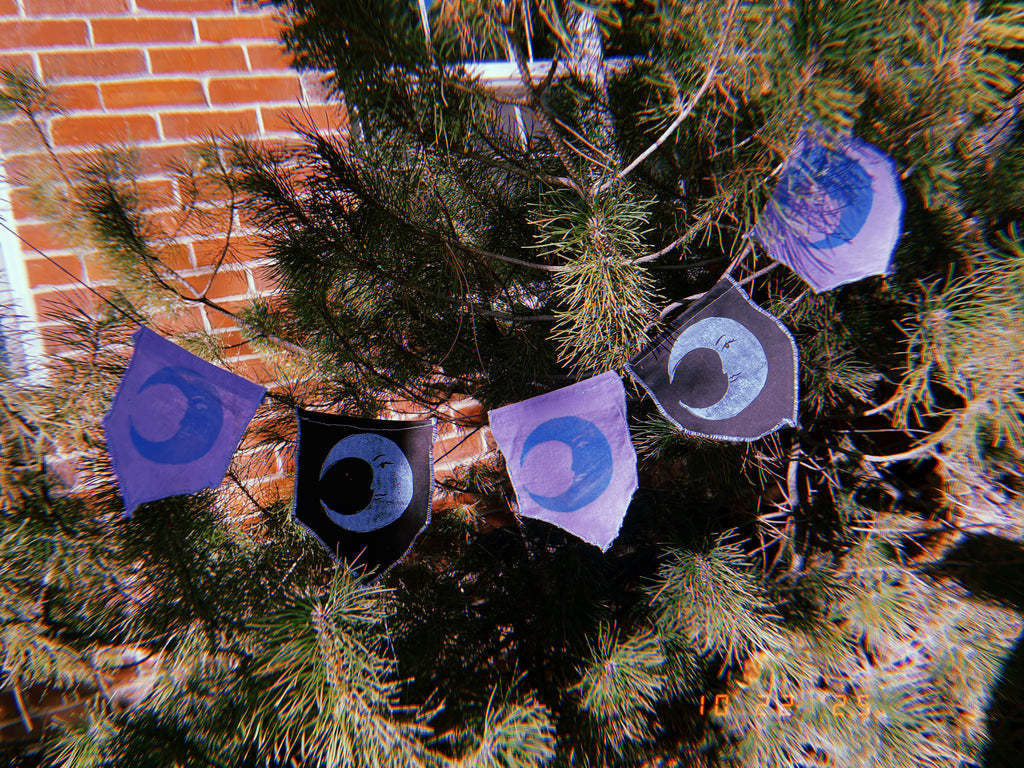 5-flag whimsigoth moon bunting garland, blue, purple, and black.
