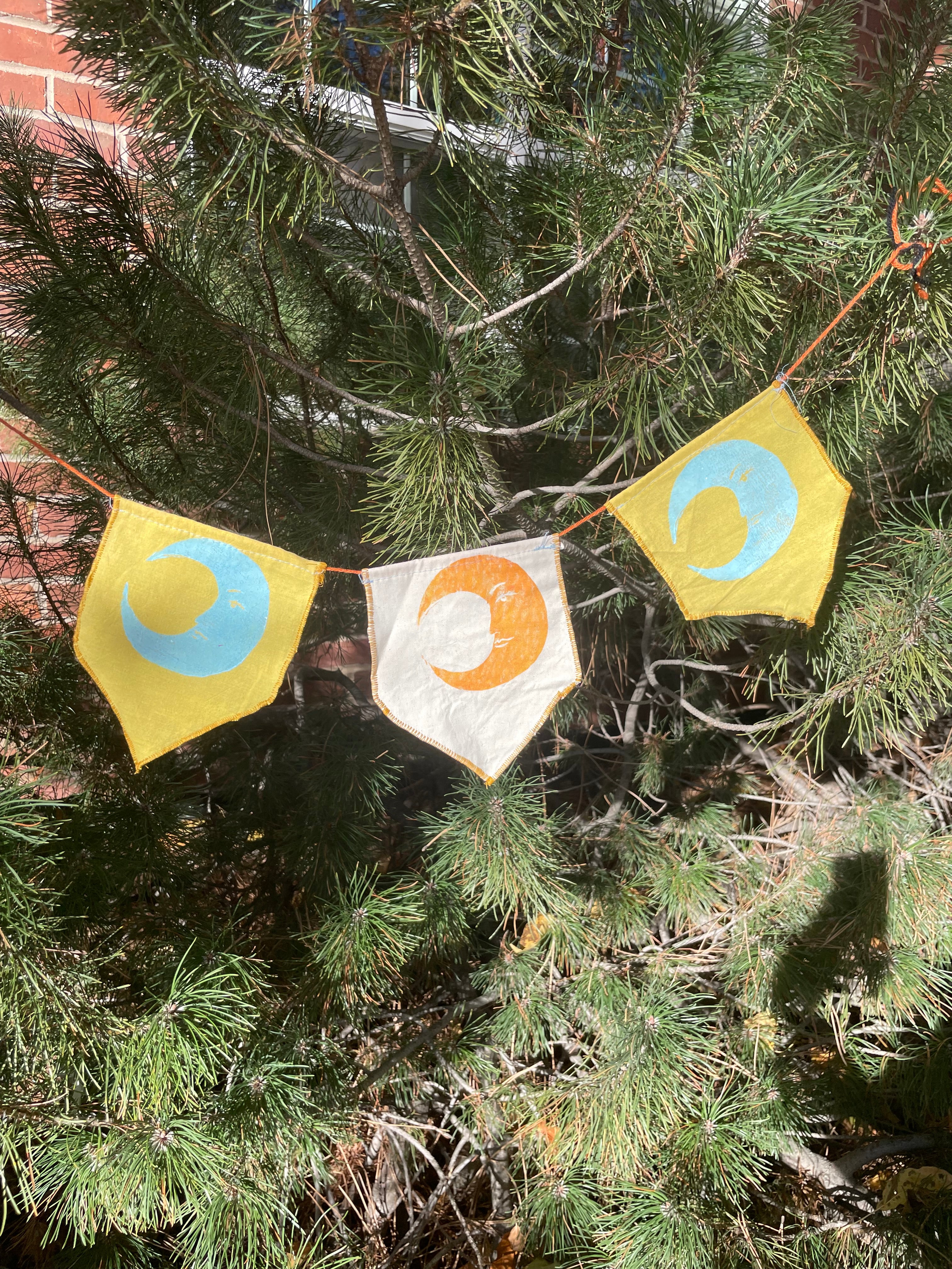 3-flag whimsigoth moon bunting garland, blue, yellow, and gold.