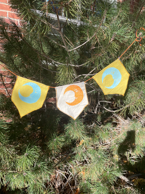 3-flag whimsigoth moon bunting garland, blue, yellow, and gold.