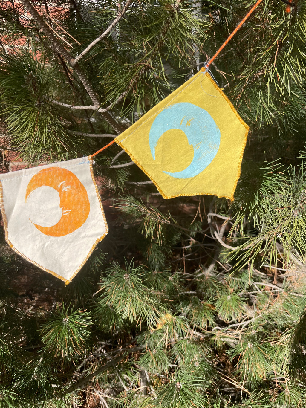 3-flag whimsigoth moon bunting garland, blue, yellow, and gold.