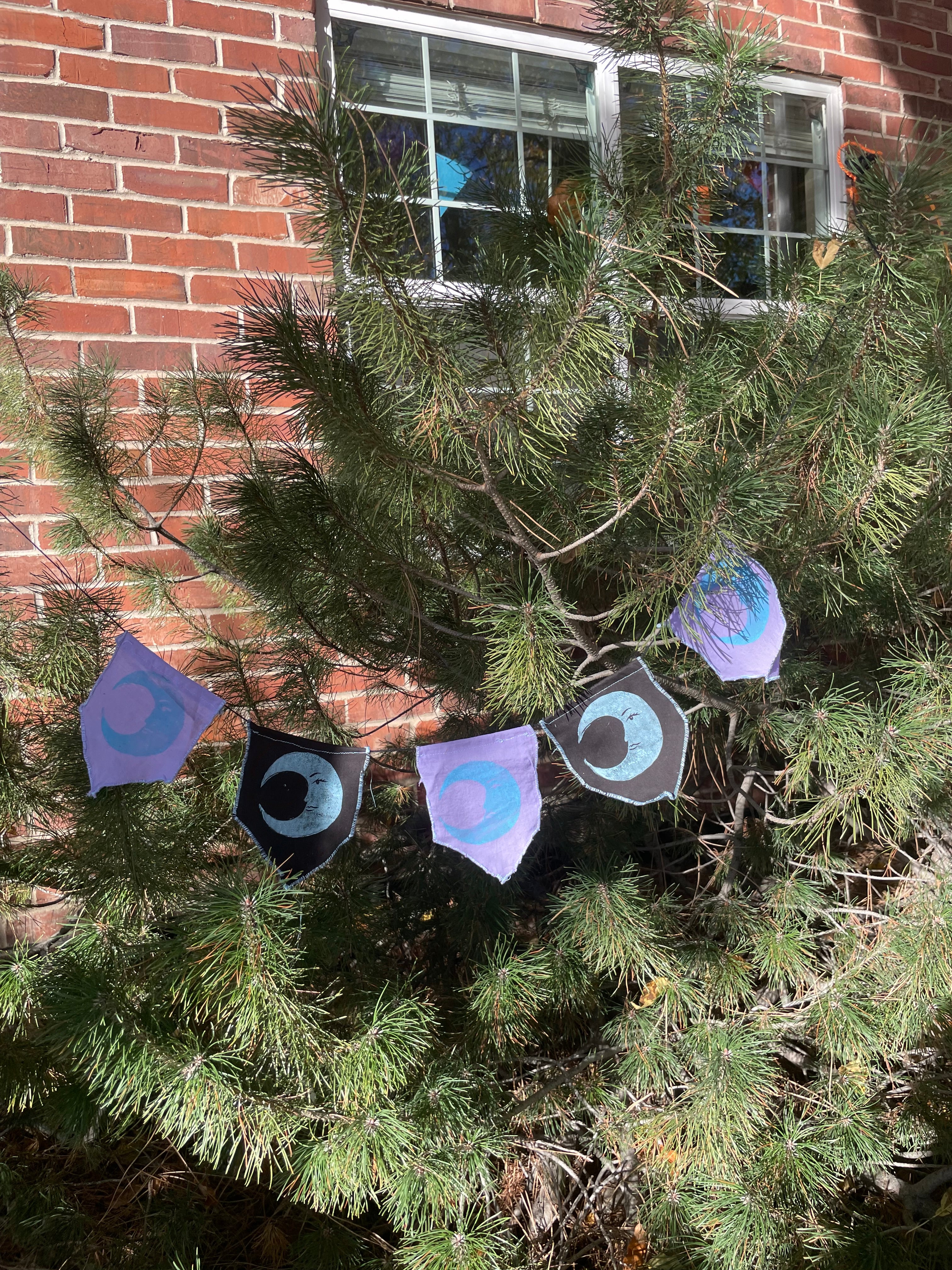 5-flag whimsigoth moon bunting garland, blue, purple, and black.