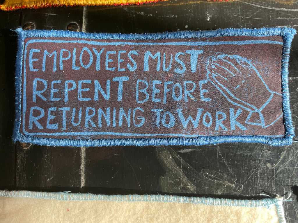 Textile patch with printed message on a dark surface