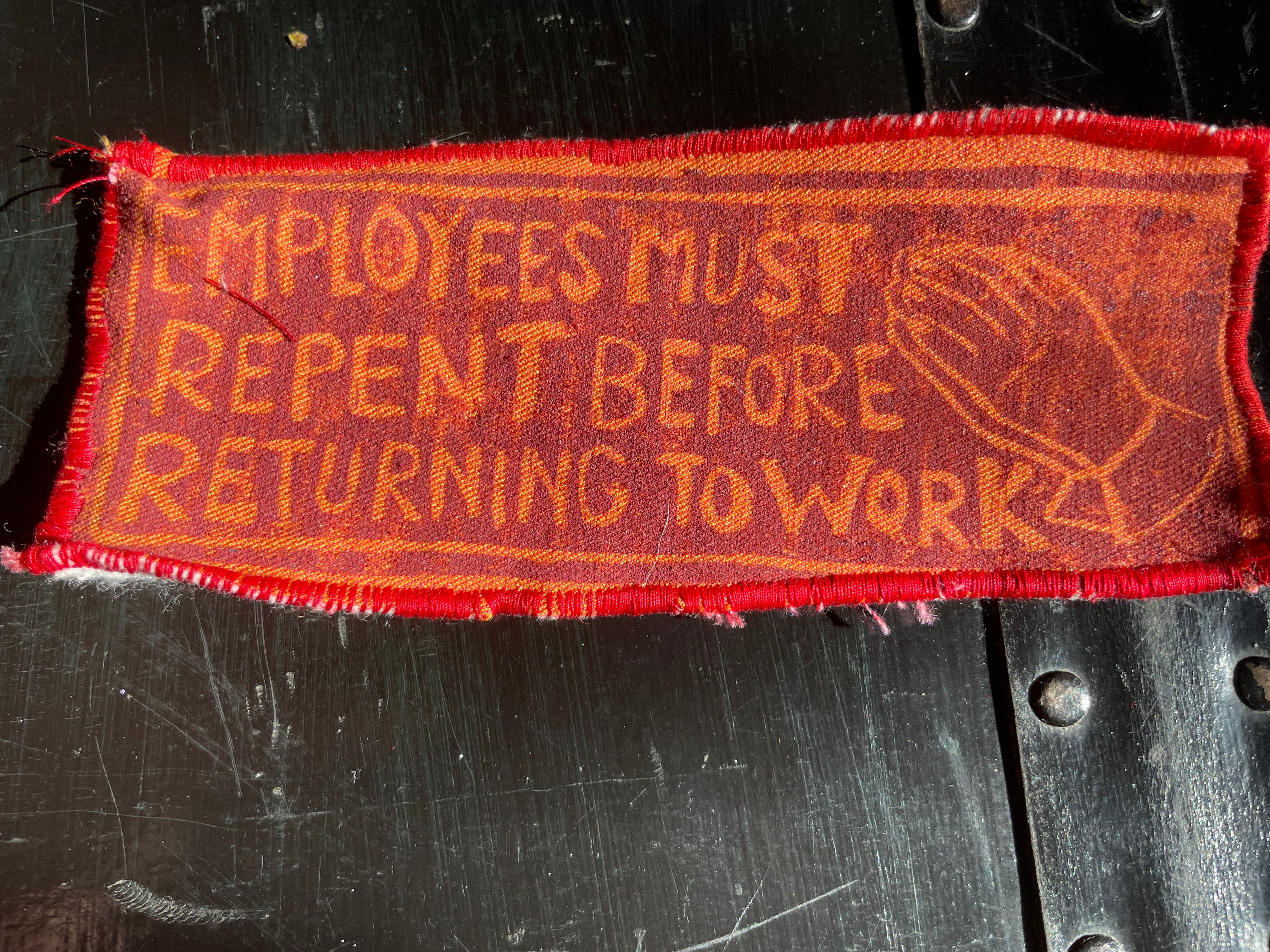 Textile patch with orange print on a black background