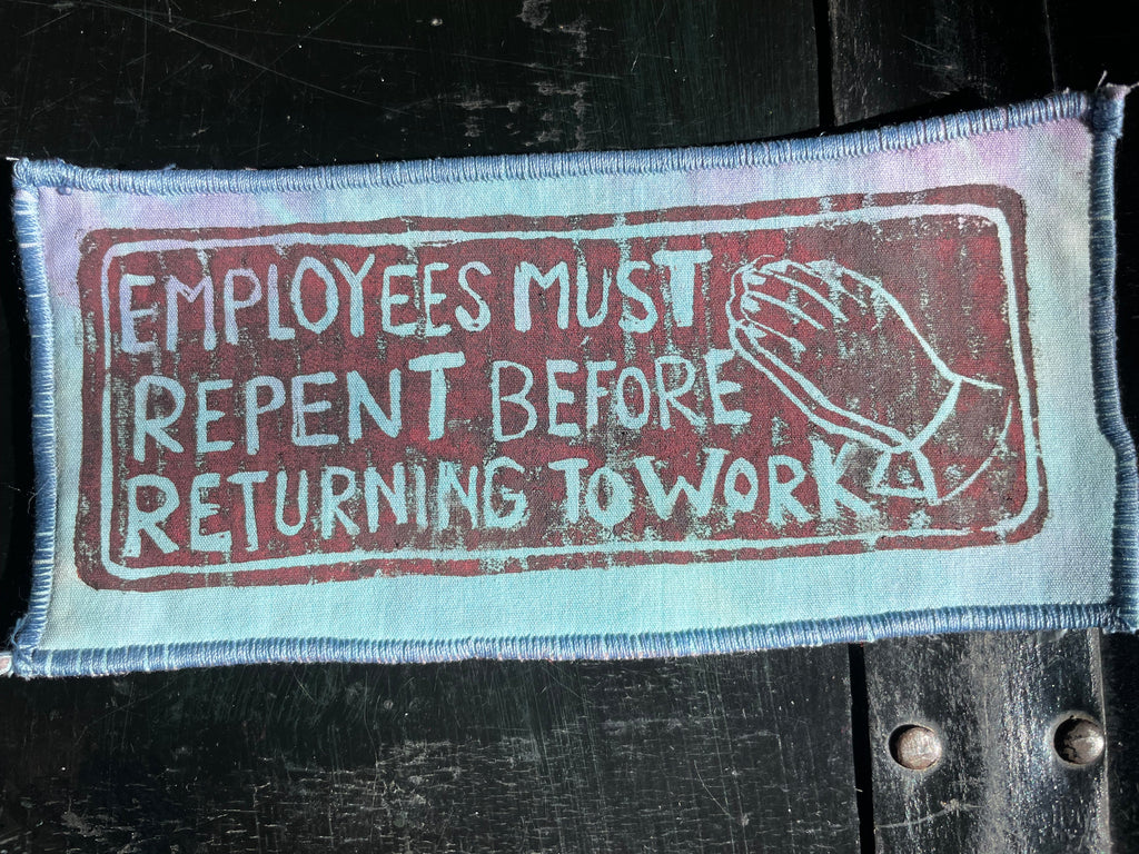 Tie Dye textile patch with printed message on a dark background